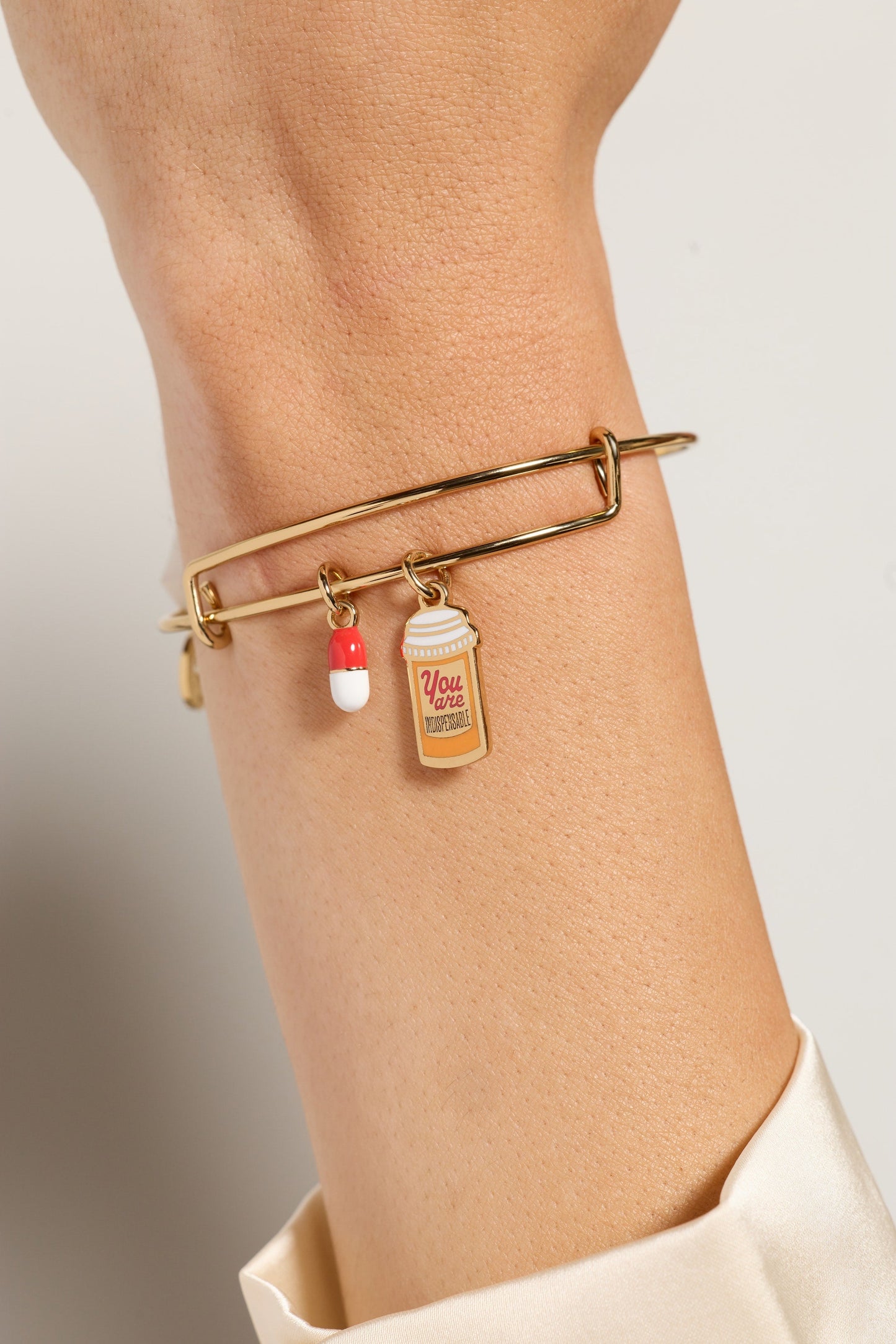You Are Indispensable' Pill Bottle Bangle
    
    
    
       Gold